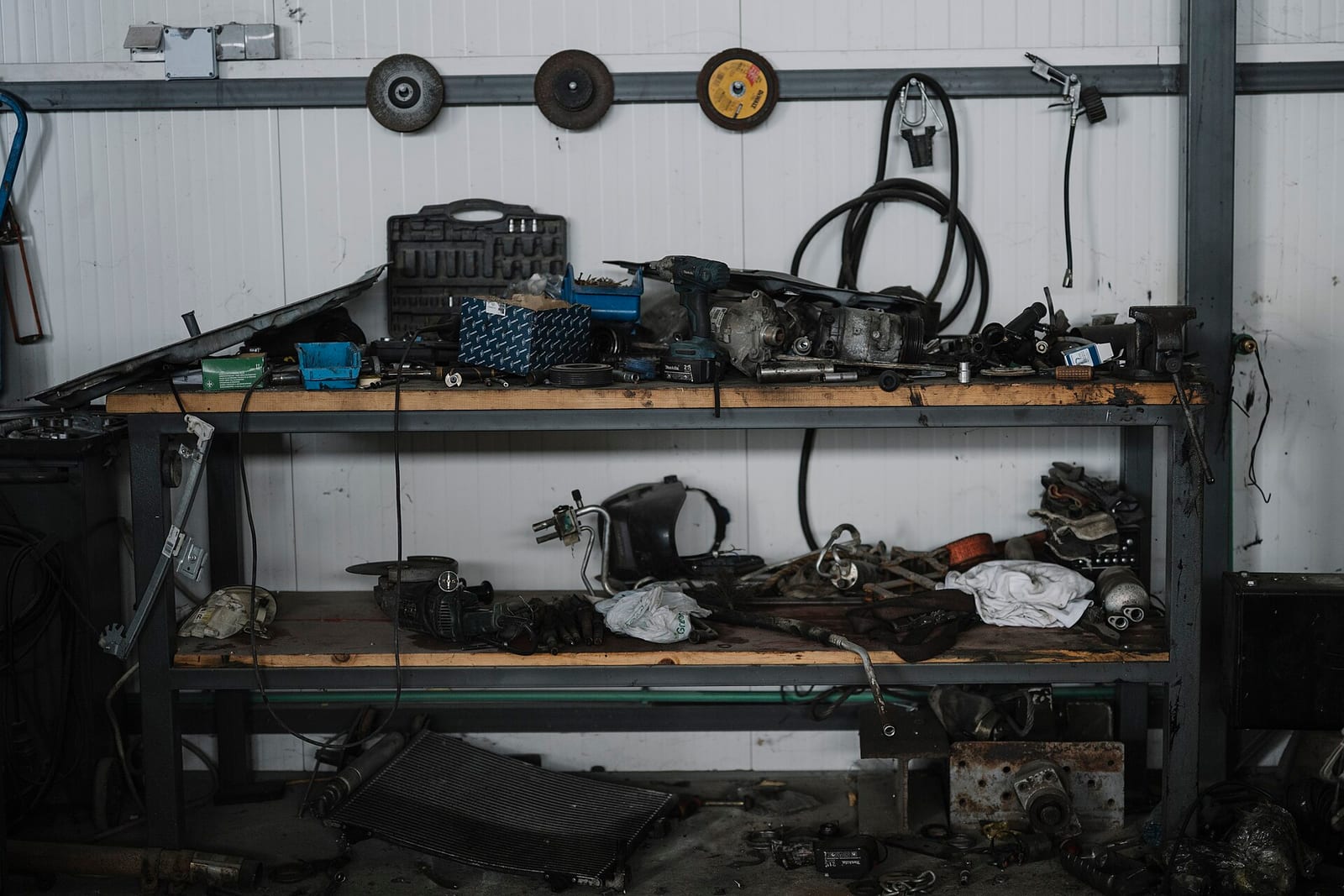 Tools and small parts arranged on a garage workbench