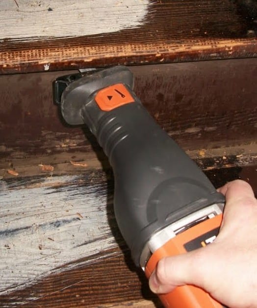 A saw cutting through embedded nails